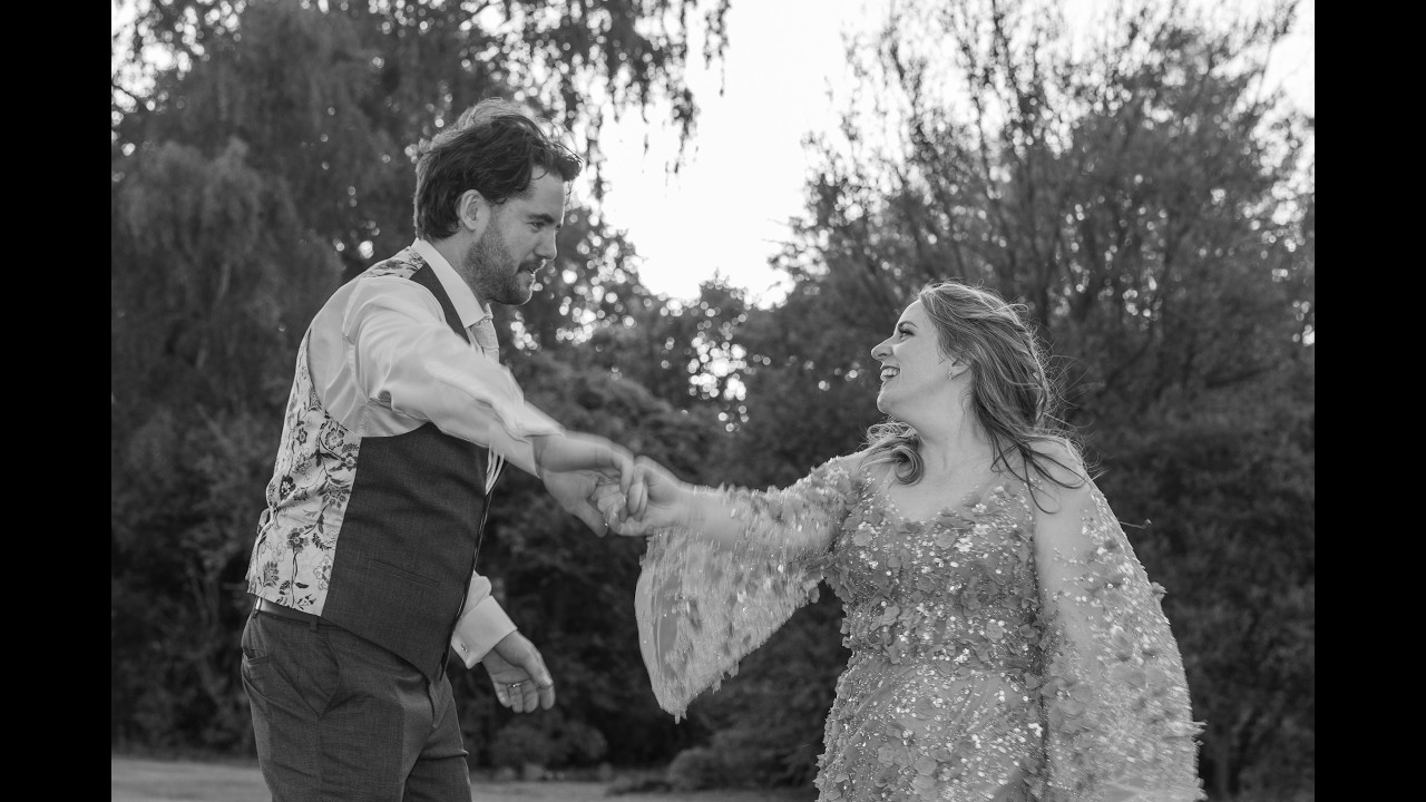 Rhiannon and John laughing together in their wedding highlight reel
